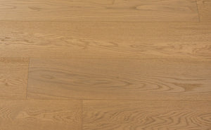 A picture of Naples hardwood from the Wildwood Nature collection. The hardwood is a light beige-caramel colour and there are little to no knots or minor variations in the hardwood, due to the high grade of wood.