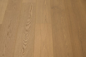 A picture of Naples hardwood from the Wildwood Nature collection. The hardwood is a light beige-caramel colour and there are little to no knots or minor variations in the hardwood, due to the high grade of wood.