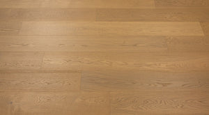 A picture of Naples hardwood from the Wildwood Nature collection. The hardwood is a light beige-caramel colour and there are little to no knots or minor variations in the hardwood, due to the high grade of wood.