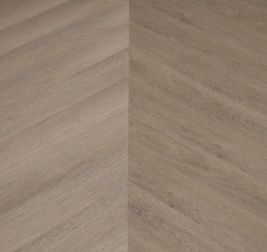 A picture showing the 6.5mm lvp flooring called Saigon in the chevron pattern. This vinyl floor is uniquely crafted and can only be installed in the chevron pattern. It has a light medium beige hue and silver chain embossing, giving the floor an ultra-realistic look.