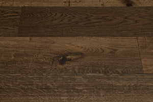 A picture showing Denver hardwood from the Wildwood Nature collection. The photo shows some minor variation from board to board. The hardwood is a dark brown smoked oak with a wire-brushed surface.
