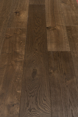 A picture showing Denver hardwood from the Wildwood Nature collection. The photo shows some minor variation from board to board. The hardwood is a dark brown smoked oak with a wire-brushed surface.