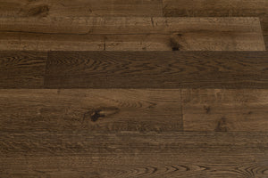 A picture showing Denver hardwood from the Wildwood Nature collection. The photo shows some minor variation from board to board. The hardwood is a dark brown smoked oak with a wire-brushed surface.