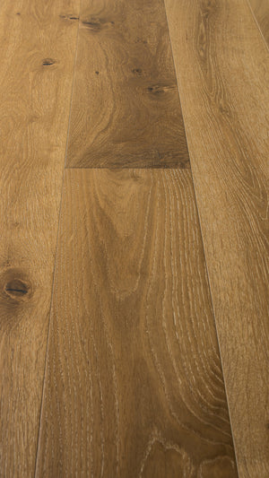 A photo showing the hardwood called Kurang from the Wildwood Nature Collection. The hardwood is an amber colour with a very light white washing that accentuates the wood grain. There is some variation and knots.