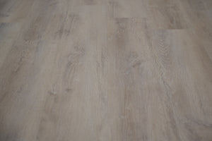 A picture showing the 6.5mm lvp flooring called Mumbai. It has a light grey-beige hue and silver chain embossing, giving the floor an ultra-realistic look.