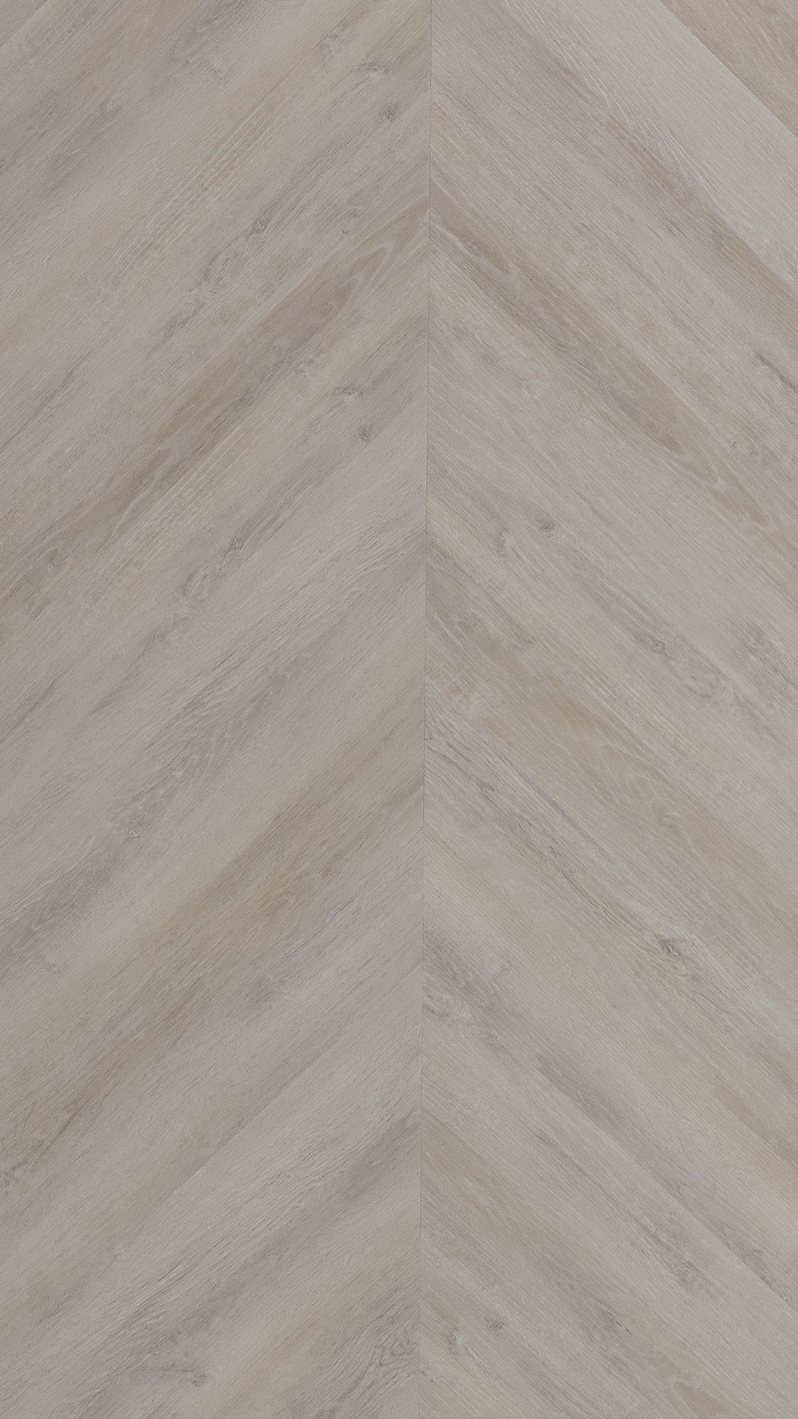 A picture showing the 6.5mm lvp flooring called Mumbai in the chevron pattern. This vinyl floor is uniquely crafted and can only be installed in the chevron pattern. It has a light grey-beige hue and silver chain embossing, giving the floor an ultra-realistic look.