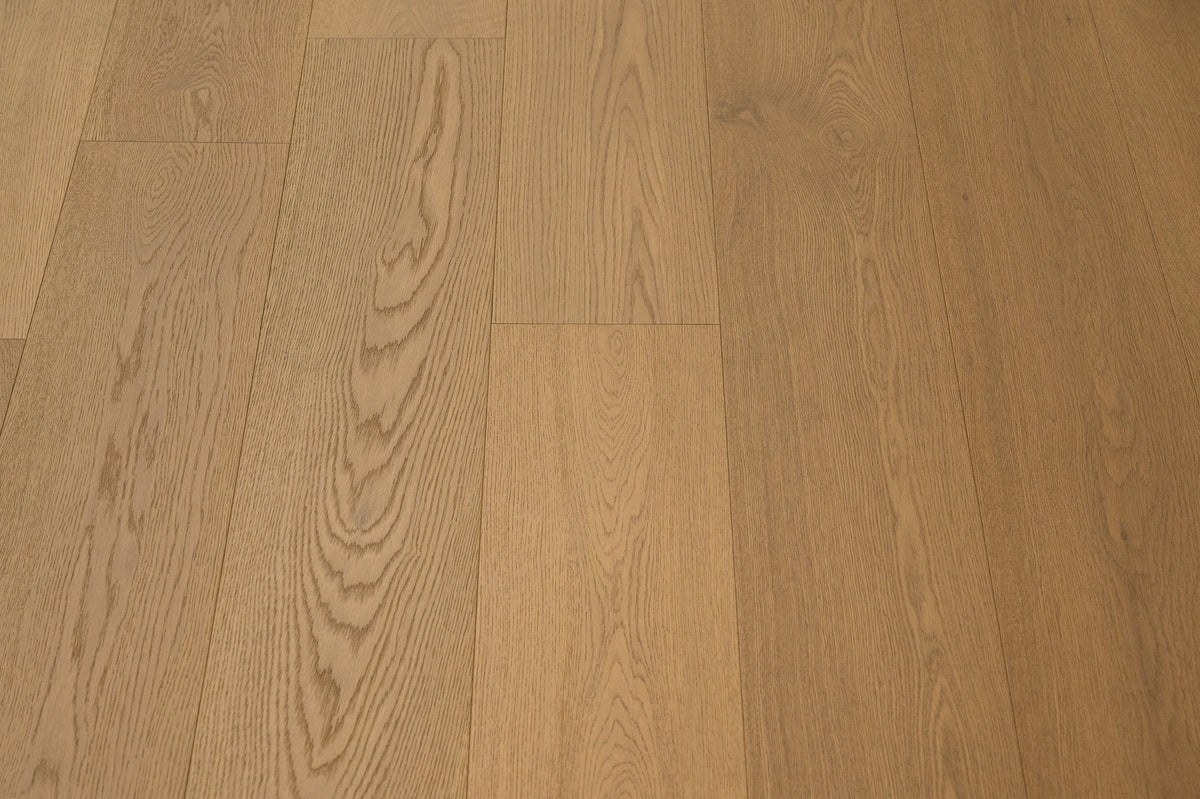 A picture of Naples hardwood from the Wildwood Nature collection. The hardwood is a light beige-caramel colour and there are little to no knots or minor variations in the hardwood, due to the high grade of wood.