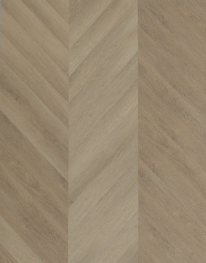 A picture showing the 6.5mm lvp flooring called Saigon in the chevron pattern. This vinyl floor is uniquely crafted and can only be installed in the chevron pattern. It has a light medium beige hue and silver chain embossing, giving the floor an ultra-realistic look.