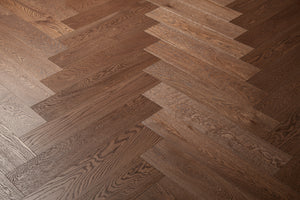 A photo showing the hardwood Como from the Wildwood Nature Herringbone Collection. This hardwood is dark brown stained and the high grade of wood means minimal knots and variation from board to board.