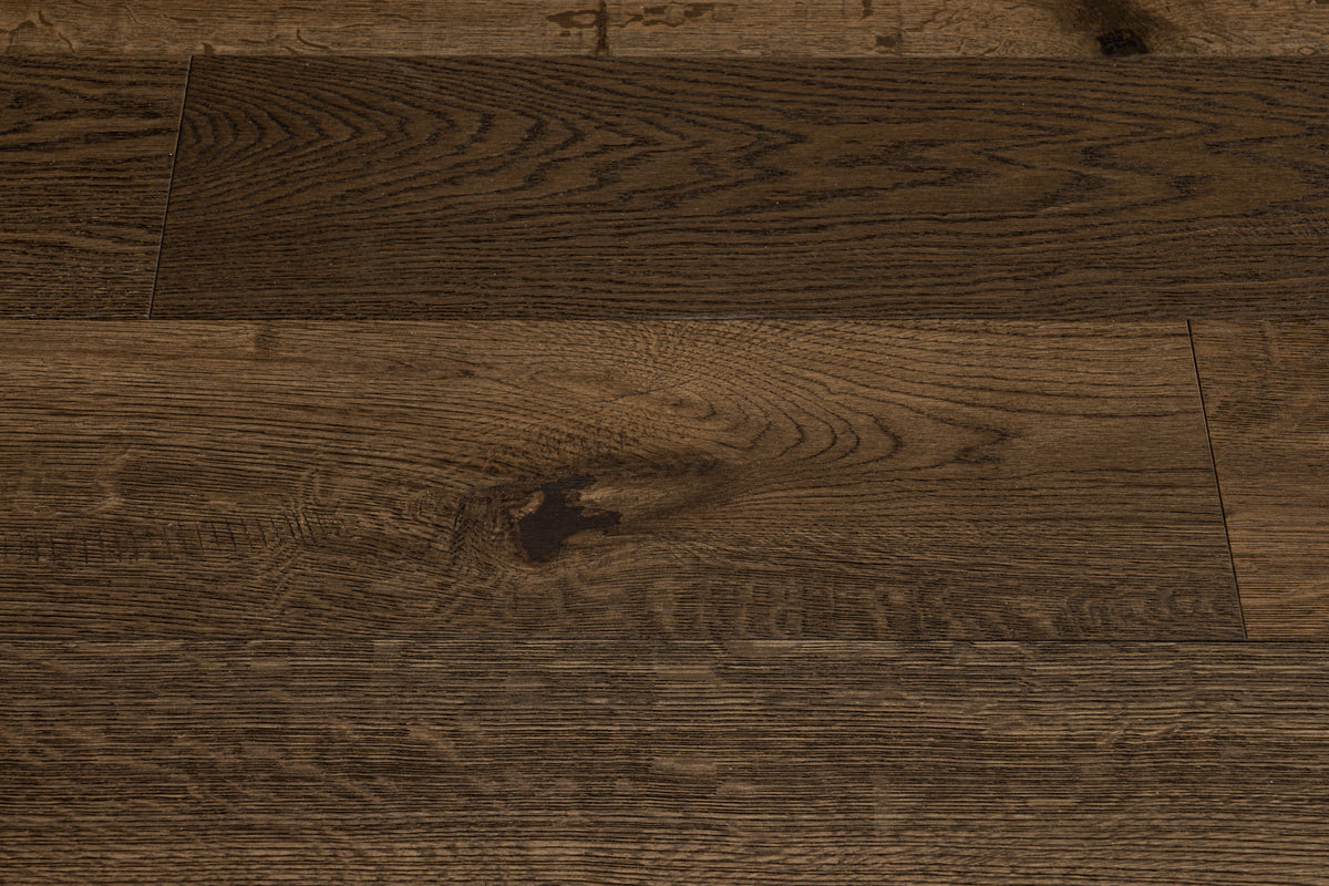 A picture showing Denver hardwood from the Wildwood Nature collection. The photo shows some minor variation from board to board. The hardwood is a dark brown smoked oak with a wire-brushed surface.