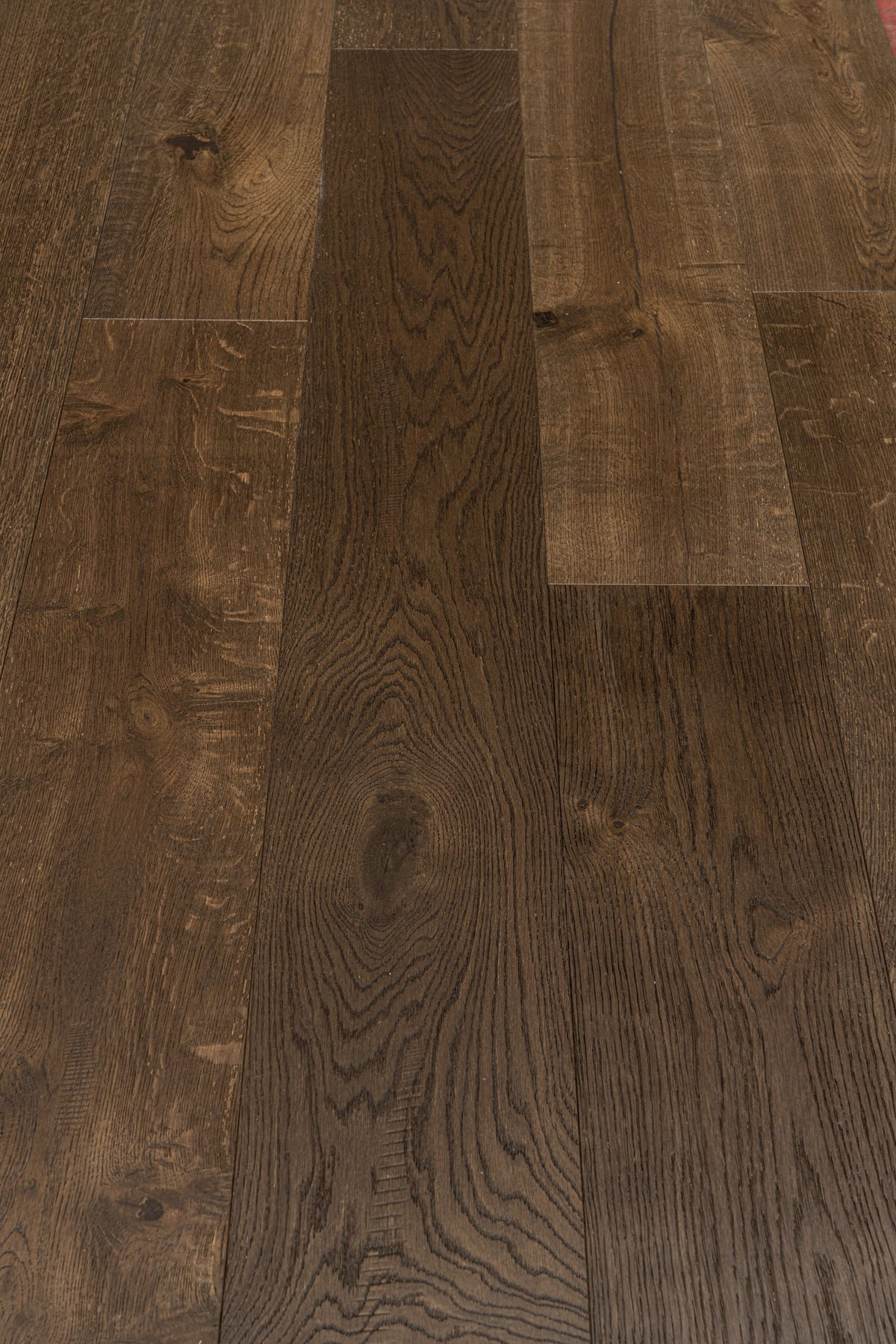 A picture showing Denver hardwood from the Wildwood Nature collection. The photo shows some minor variation from board to board. The hardwood is a dark brown smoked oak with a wire-brushed surface.