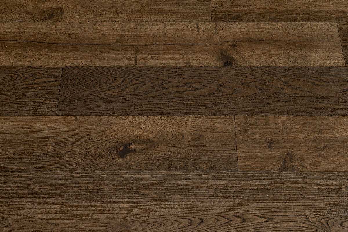 A picture showing Denver hardwood from the Wildwood Nature collection. The photo shows some minor variation from board to board. The hardwood is a dark brown smoked oak with a wire-brushed surface.