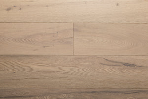 A picture of the oak  hardwood flooring called Dublin from the Wildwood Antique Collection, showing some minor knots and variation with a light, white-washed hue and beige tones.