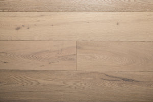 A picture of the oak  hardwood flooring called Dublin from the Wildwood Antique Collection, showing some minor knots and variation with a light, white-washed hue and beige tones.