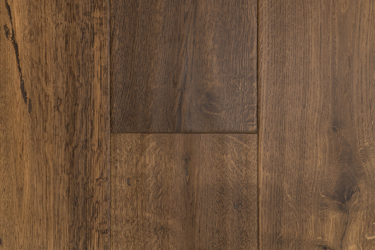 A picture showing the oak hardwood called Geneva from the Wildwood Nature Collection. The hardwood is a brown-amber colour, with some areas of darker tones and some with lighter tones. The floor is lightly hand scrapped and has a beautiful, rustic look, reminiscent of flooring found in old european castles.
