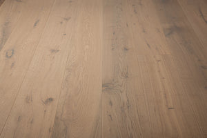 A picture of the oak  hardwood flooring called Istanbul from the Wildwood Antique Collection, showing some knots and variation with a grey and beige tones.