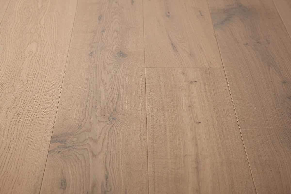 A picture of the oak  hardwood flooring called Istanbul from the Wildwood Antique Collection, showing some knots and variation with a grey and beige tones.