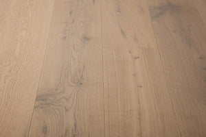 A picture of the oak  hardwood flooring called Istanbul from the Wildwood Antique Collection, showing some knots and variation with a grey and beige tones.