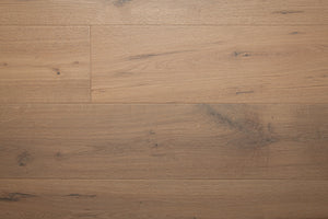 A picture of the oak  hardwood flooring called Istanbul from the Wildwood Antique Collection, showing some knots and variation with a grey and beige tones.