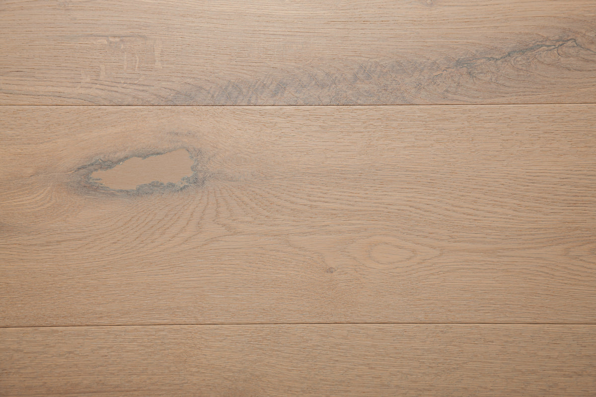 A picture of the oak  hardwood flooring called Istanbul from the Wildwood Antique Collection, showing some knots and variation with a grey and beige tones.