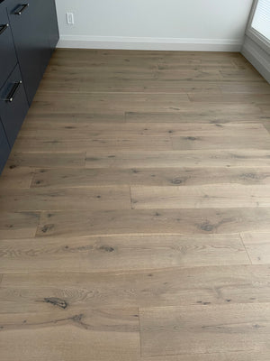 A picture of Istanbul hardwood installed in a custom built home. There is lots of natural light filtering through the nearby windows of the kitchen.