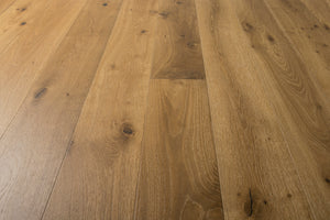 A photo showing the hardwood called Kurang from the Wildwood Nature Collection. The hardwood is an amber colour with a very light white washing that accentuates the wood grain. There is some variation and knots.