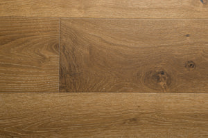 A photo showing the hardwood called Kurang from the Wildwood Nature Collection. The hardwood is an amber colour with a very light white washing that accentuates the wood grain. There is some variation and knots.