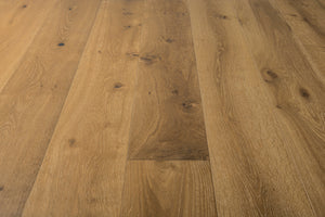 A photo showing the hardwood called Kurang from the Wildwood Nature Collection. The hardwood is an amber colour with a very light white washing that accentuates the wood grain. There is some variation and knots.