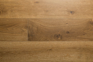 A photo showing the hardwood called Kurang from the Wildwood Nature Collection. The hardwood is an amber colour with a very light white washing that accentuates the wood grain. There is some variation and knots.