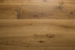 A photo showing the hardwood called Kurang from the Wildwood Nature Collection. The hardwood is an amber colour with a very light white washing that accentuates the wood grain. There is some variation and knots.