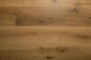 A photo showing the hardwood called Kurang from the Wildwood Nature Collection. The hardwood is an amber colour with a very light white washing that accentuates the wood grain. There is some variation and knots.