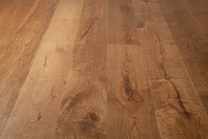 A picture of the oak  hardwood flooring called Oak Natural from the Wildwood Antique Collection, showing some knots and variation with a brown-red tone.