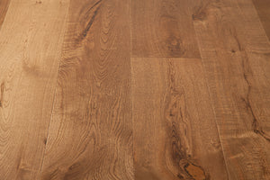 A picture of the oak  hardwood flooring called Oak Natural from the Wildwood Antique Collection, showing some knots and variation with a brown-red tone.