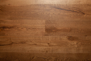 A picture of the oak  hardwood flooring called Oak Natural from the Wildwood Antique Collection, showing some knots and variation with a brown-red tone.