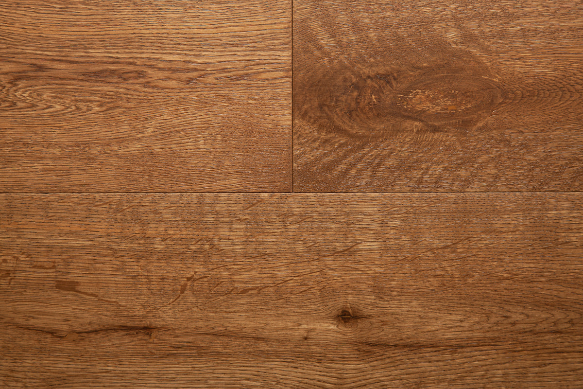 A picture of the oak  hardwood flooring called Oak Natural from the Wildwood Antique Collection, showing some knots and variation with a brown-red tone.