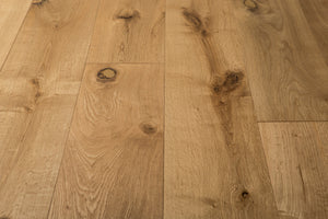 A picture of the oak  hardwood flooring called Oak Natural from the Wildwood Antique Collection, showing some knots and variation with a light amber tone.