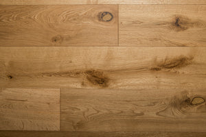 A picture of the oak  hardwood flooring called Oak Natural from the Wildwood Antique Collection, showing some knots and variation with a light amber tone.