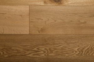 A picture of the oak  hardwood flooring called Oak Natural from the Wildwood Antique Collection, showing some knots and variation with a light amber tone.