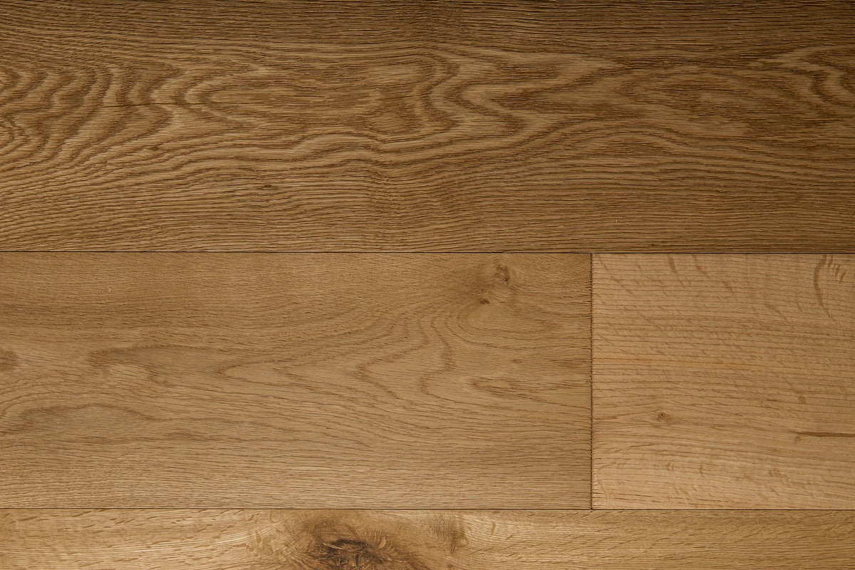 A picture of the oak  hardwood flooring called Oak Natural from the Wildwood Antique Collection, showing some knots and variation with a light amber tone.