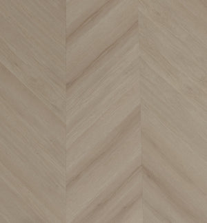 A picture showing the 6.5mm lvp flooring called Pompeii in the chevron pattern. This vinyl floor is uniquely crafted and can only be installed in the chevron pattern. It has a light medium beige hue and silver chain embossing, giving the floor an ultra-realistic look.