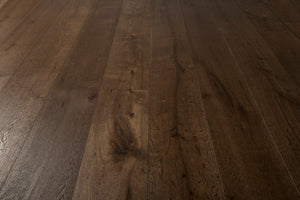 A picture of the oak  hardwood flooring called Vienna from the Wildwood Antique Collection, showing some knots and variation with a dark brown stain.