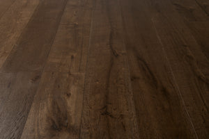 A picture of the oak  hardwood flooring called Vienna from the Wildwood Antique Collection, showing some knots and variation with a dark brown stain.